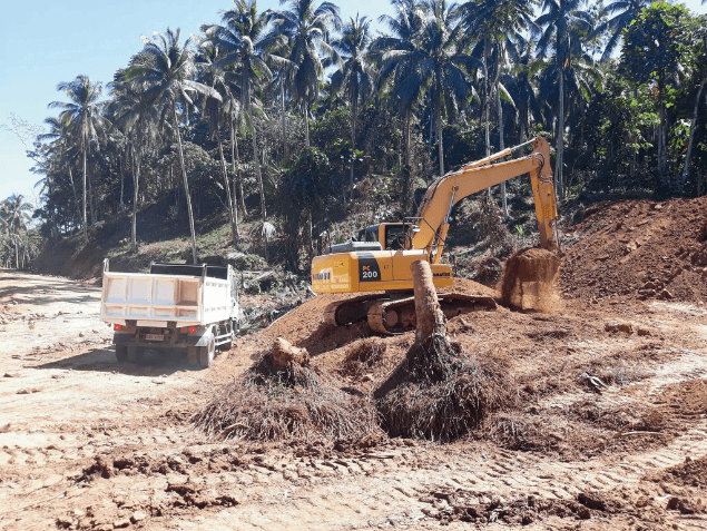 Excavator and haul truck carrying out site clearing and earthworks